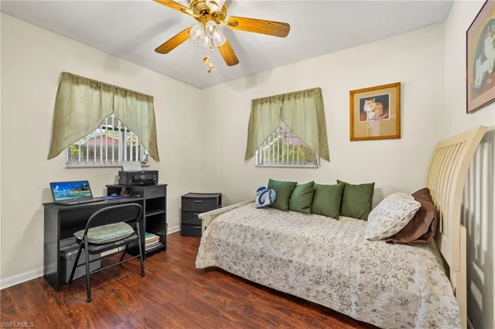 Bedroom featuring wood finished floors and a ceiling fan