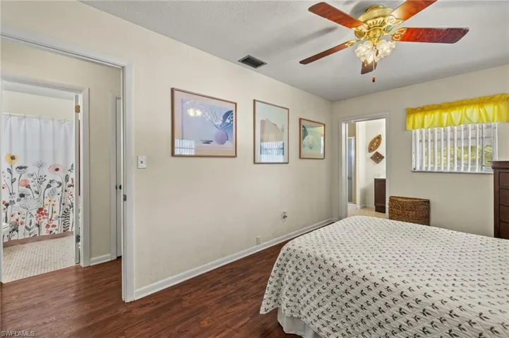 Bedroom with dark wood-style floors and a ceiling fan