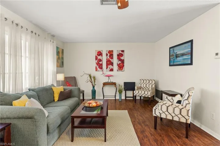 Living area with baseboards and wood finished floors