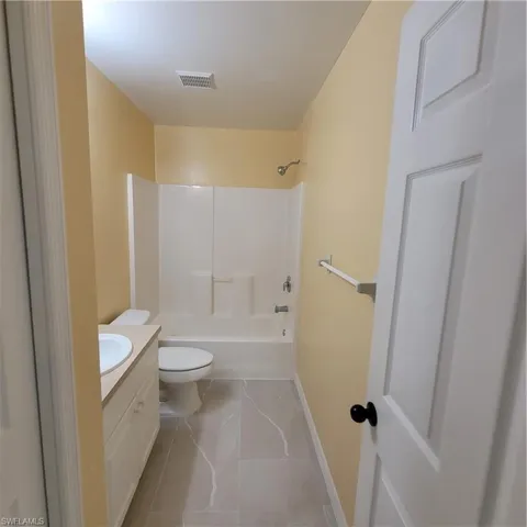 Bathroom featuring vanity and shower / tub combination