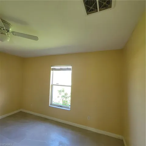 Empty room with baseboards and ceiling fan