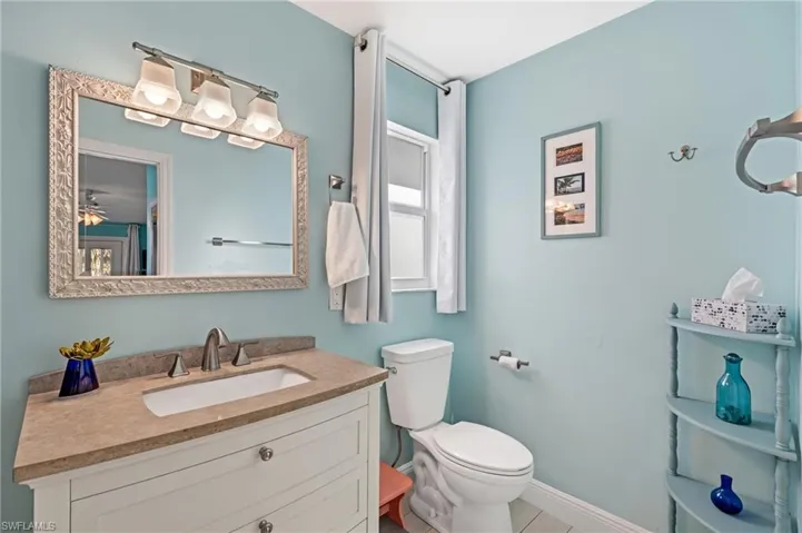 Bathroom with tile patterned flooring, vanity, and toilet