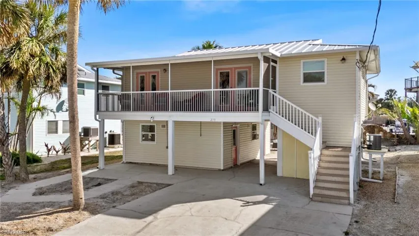 Front of house featuring French doors and central air condition unit