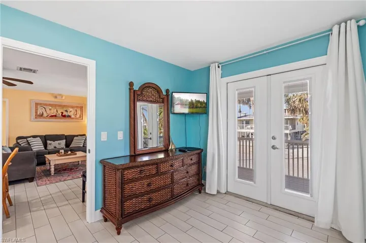 Doorway featuring french doors and ceiling fan