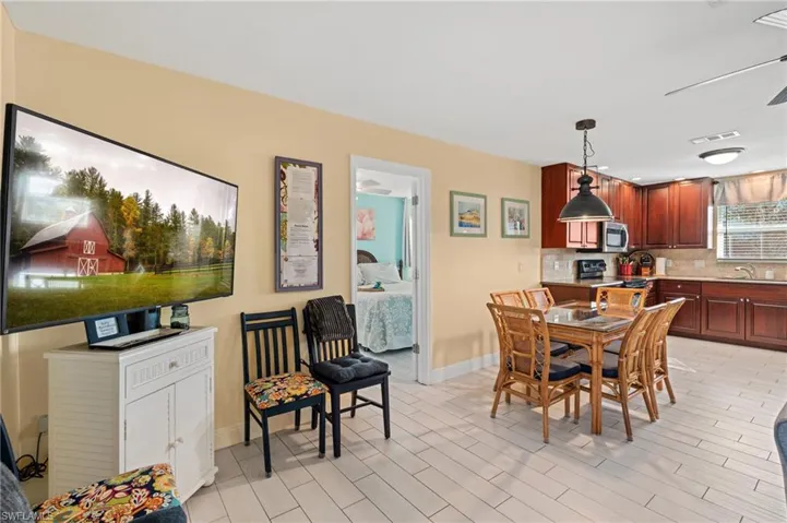 Dining area featuring sink, ceiling fan, and light wood-type flooring