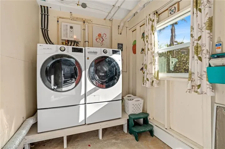 Laundry room with washer and clothes dryer