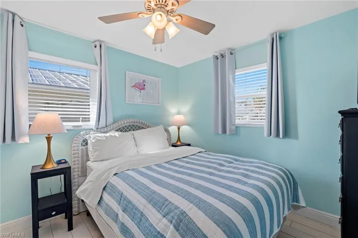 Bedroom with ceiling fan and light wood-type flooring