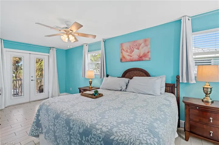 Bedroom with access to exterior, ceiling fan, and french doors