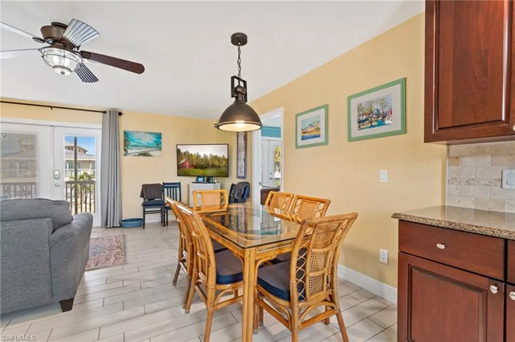 Dining room with french doors, ceiling fan, and light hardwood / wood-style floors