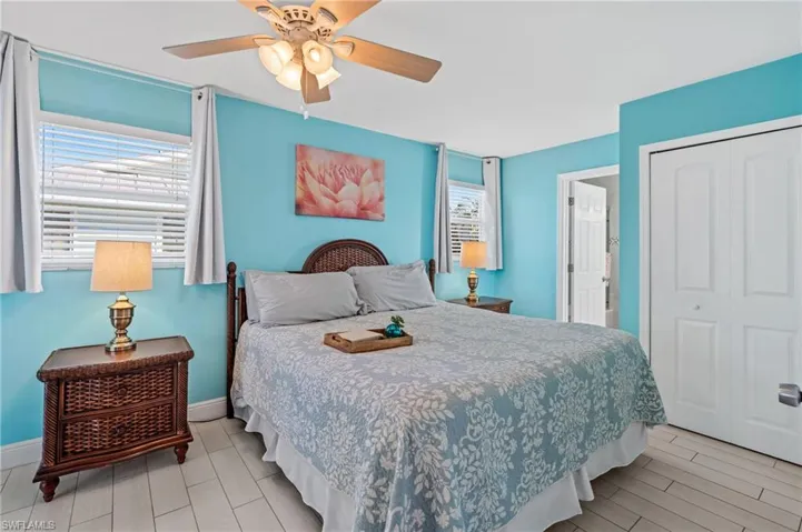 Bedroom with ceiling fan and a closet