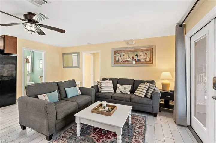 Living room featuring ceiling fan and light wood-type flooring