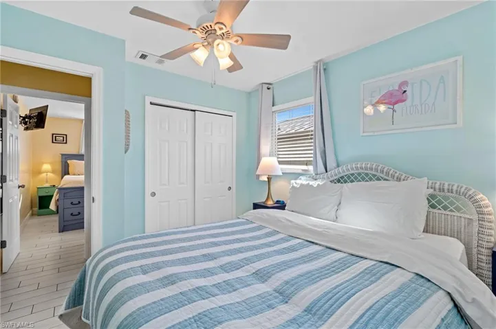 Bedroom with light hardwood / wood-style flooring, a closet, and ceiling fan