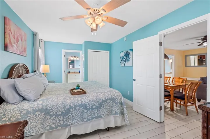 Bedroom featuring ensuite bath, ceiling fan, and a closet