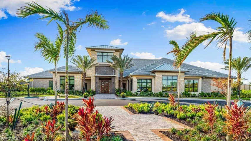 Modern Mediterranean architecture featuring a stone facade and a gray tile roof