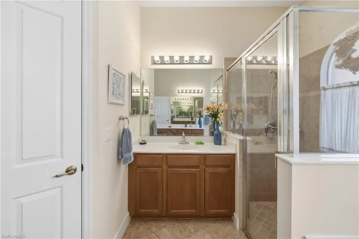 Spacious primary bathroom with dual sinks, a soaking tub, and separate shower