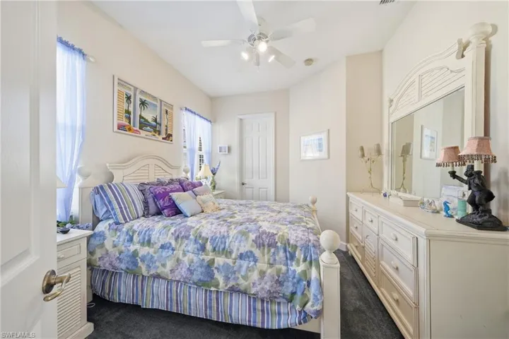Comfortable guest bedroom with natural light and a functional layout