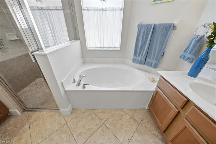 A comfortable primary bath offering both a soaking tub and separate shower