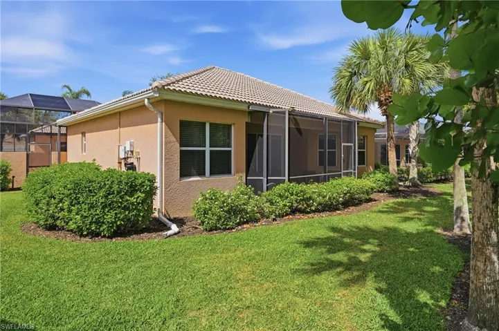 Rear exterior showcasing the private screened lanai off the living room and primary bedroom