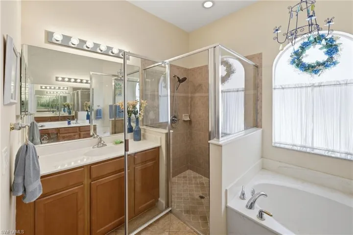 Generously sized primary bathroom with dual vanities and a relaxing bath layout