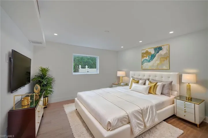 Light-filled interior featuring recessed lighting, a single window, and wood-finish flooring