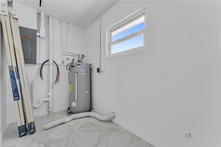 Utility room with electric panel and electric water heater