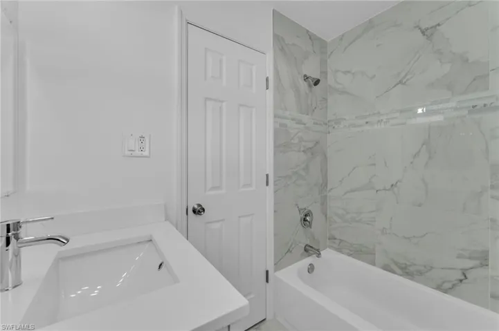 Bathroom with shower / bathtub combination and vanity