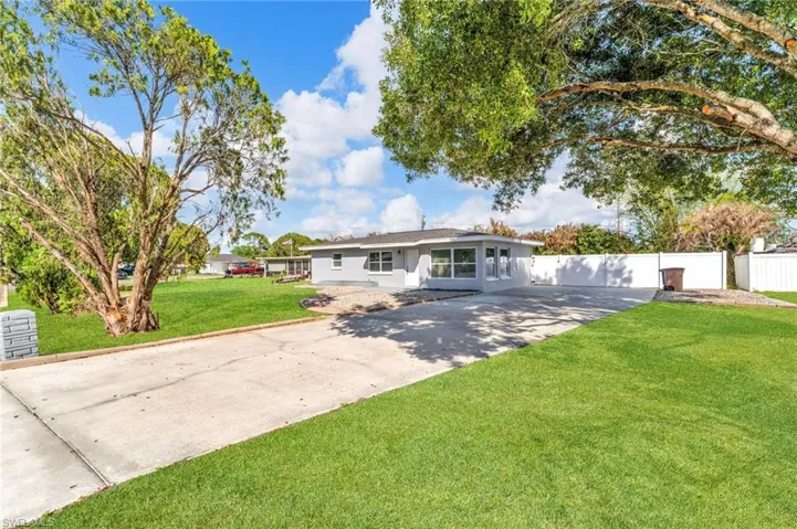 Ranch-style home featuring concrete driveway and stucco siding