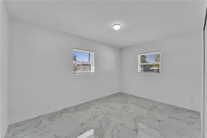 Empty room featuring light marble finish floors