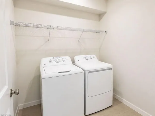Convenient upstairs laundry room with full-size washer and dryer.