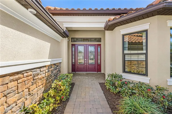 Entrance to property with stucco siding and french doors