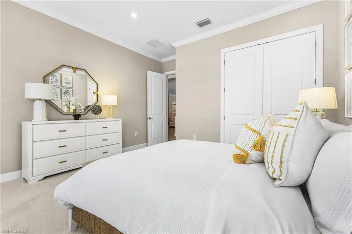 Bedroom featuring ornamental molding, carpet, and a closet