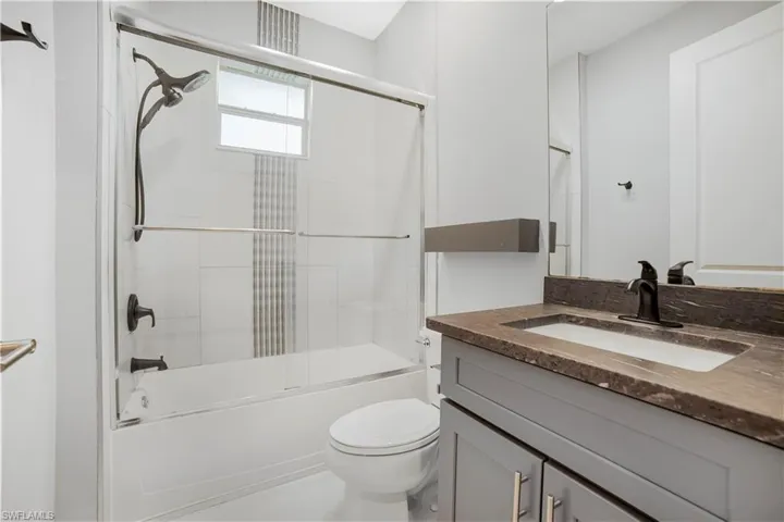Full bathroom with vanity, combined bath / shower wi