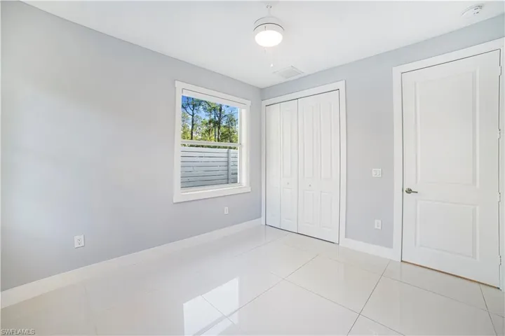 Unfurnished bedroom with a closet, ceiling fan, and light tile patterned floors