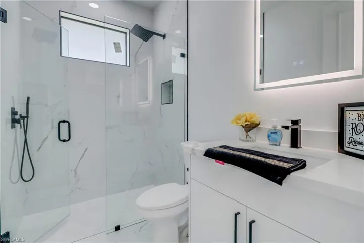 Bathroom with vanity, toilet, and walk in shower