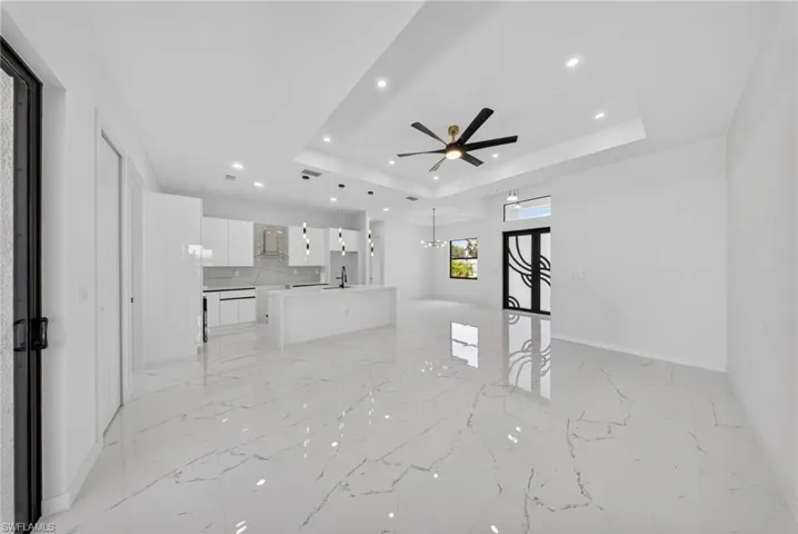 Open-concept living space with large format porcelain tile flooring