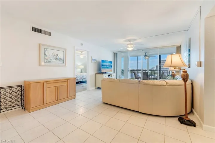 Living room featuring light tile patterned flooring and a ceiling fan