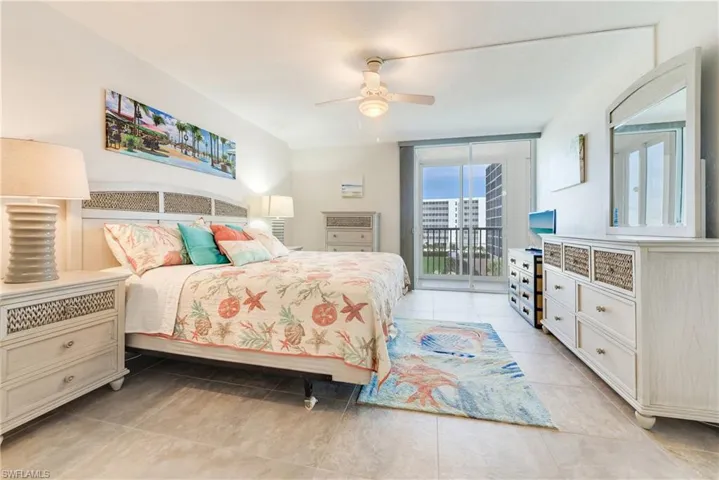 Bedroom with access to exterior, a ceiling fan, floor to ceiling windows, and light tile patterned floors
