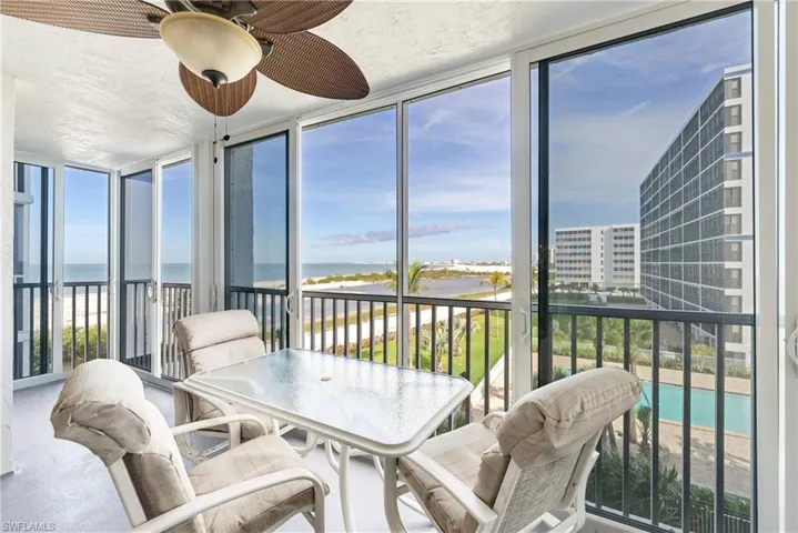 Sunroom with floor to ceiling windows, a water view, and a textured ceiling