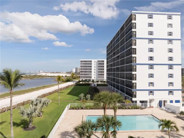 Community pool with a water view and a patio