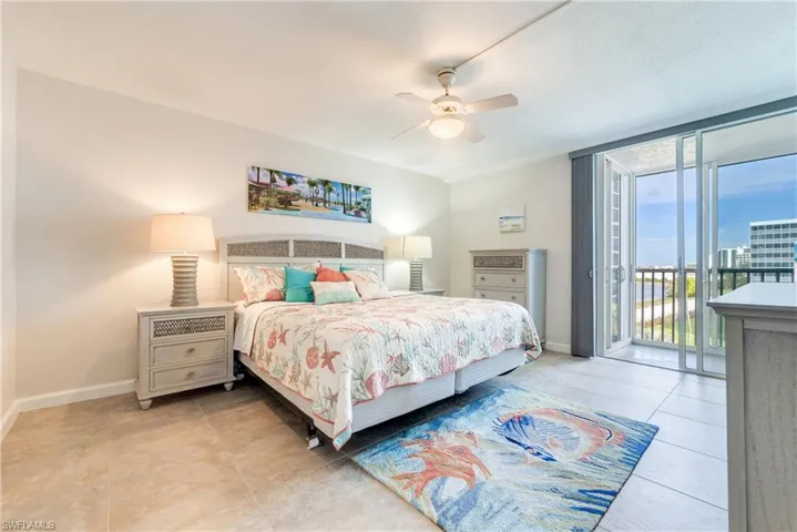 Bedroom featuring access to exterior, a ceiling fan, light tile patterned floors, and floor to ceiling windows