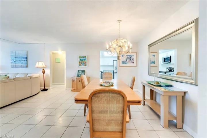 Dining room with suspended lighting and light tile patterned floors