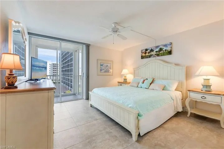 Bedroom featuring access to exterior, ceiling fan, and light tile patterned floors