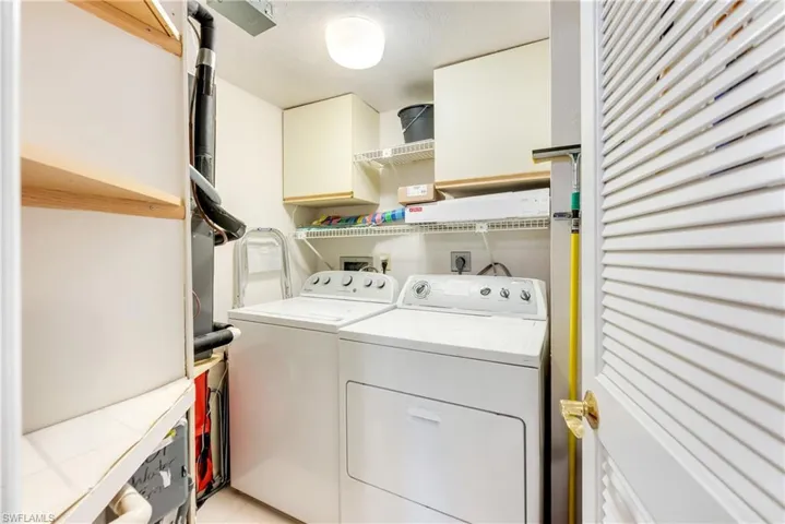 Laundry area featuring washing machine and dryer and cabinet space