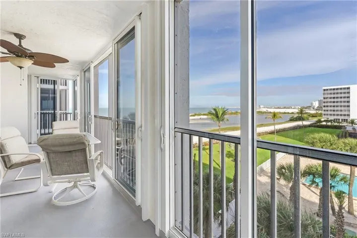 Sunroom with a water view and concrete floors