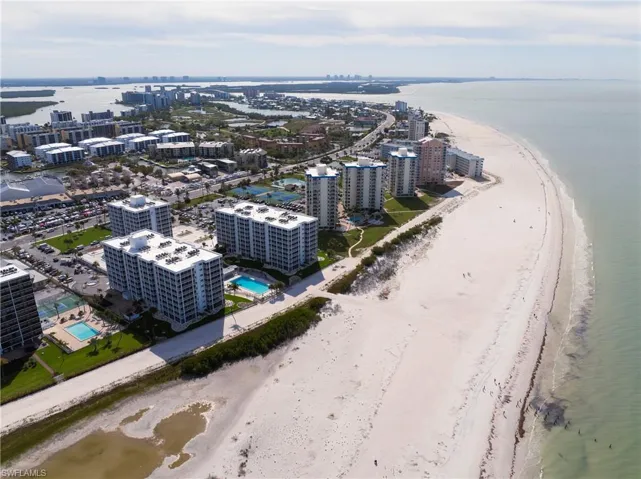 Aerial view of expansive coastline and a pool