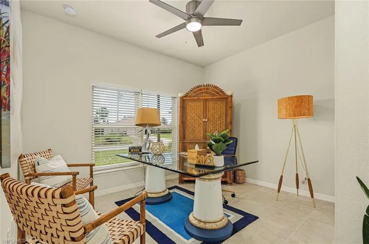 Office space featuring light tile patterned floors and ceiling fan