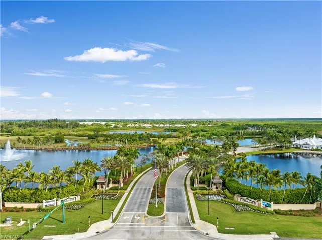Aerial view of a nearby body of water and a tree filled landscape