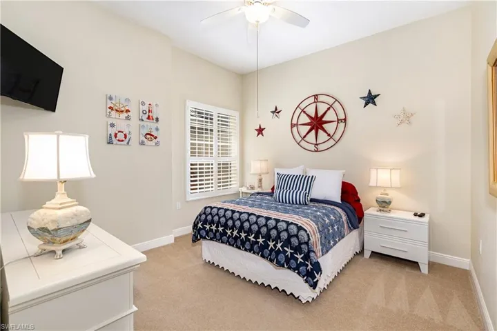 Bedroom with light colored carpet and ceiling fan