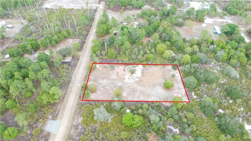 Aerial view of property and surrounding area with property parcel outlined