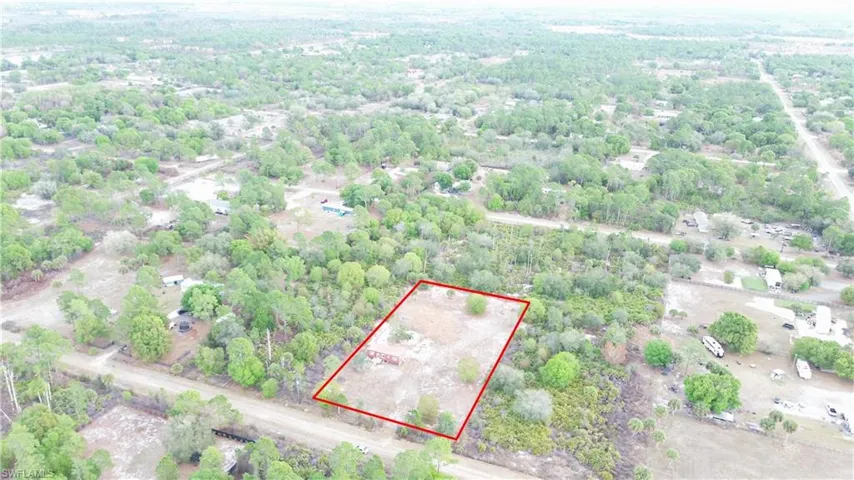 Aerial view of property and surrounding area featuring property boundaries highlighted